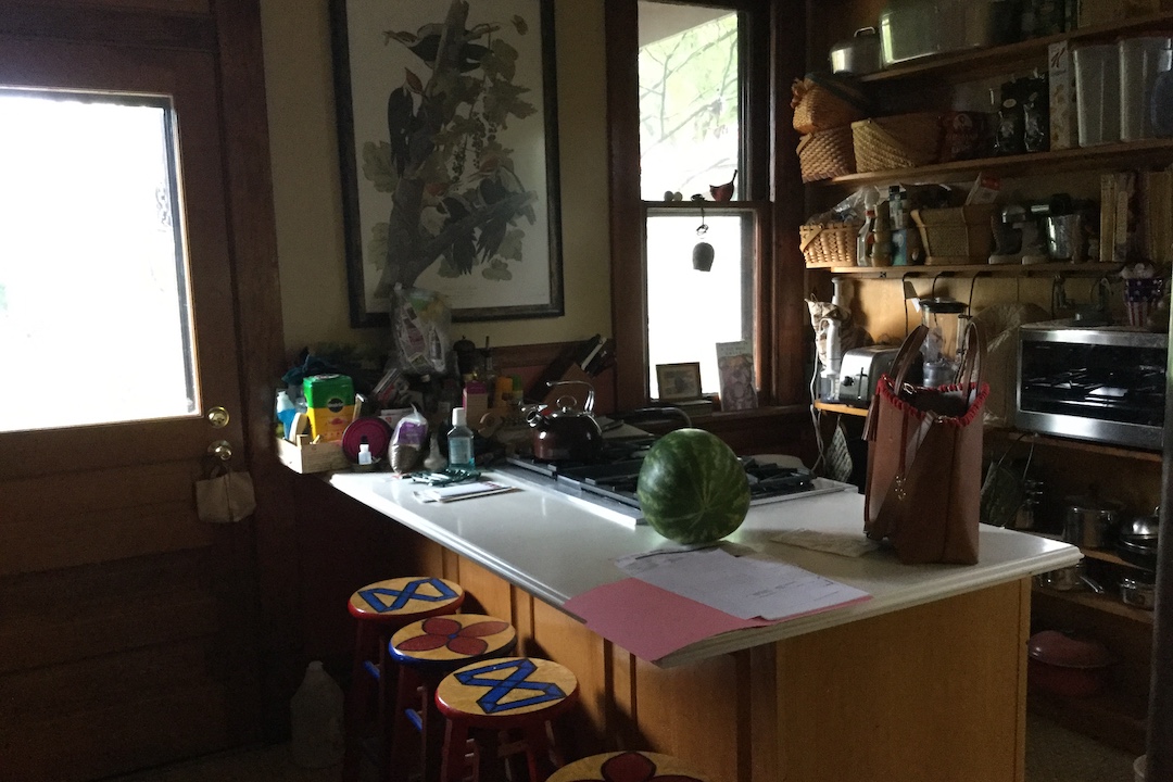 A dark and messy kitchen interior before renovation.