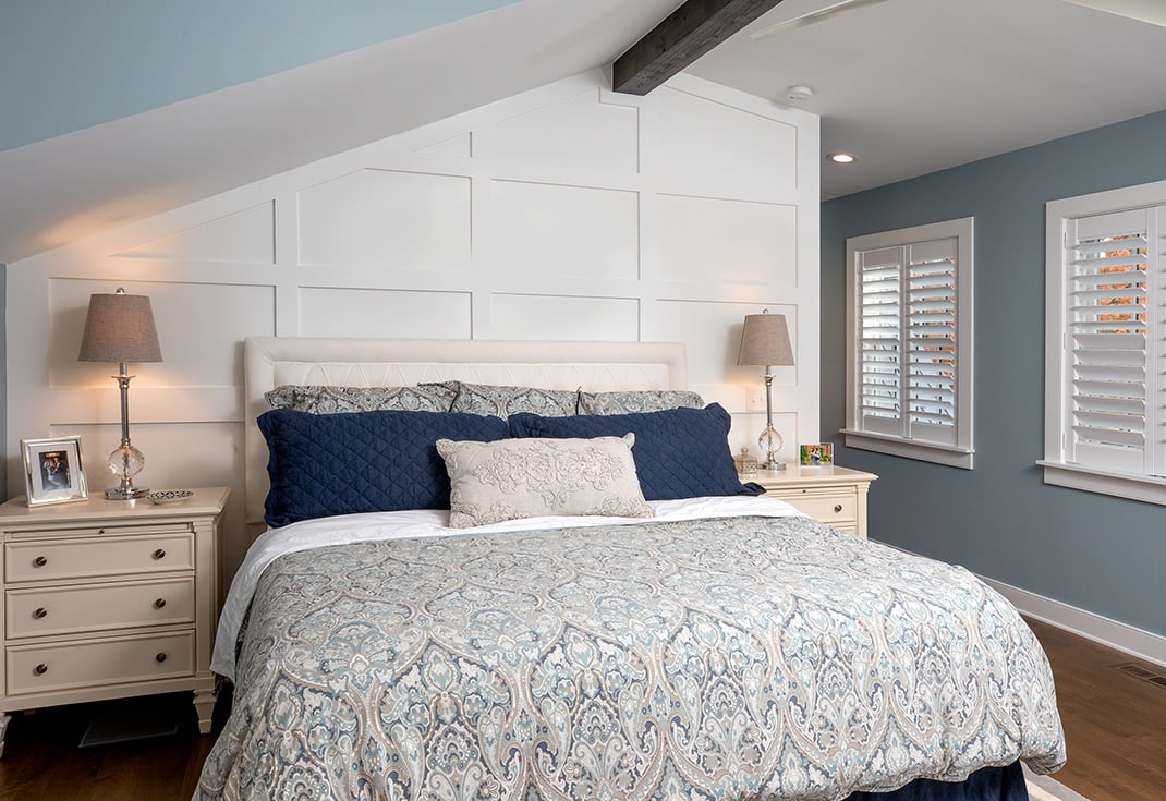 A master bedroom with wainscoting.