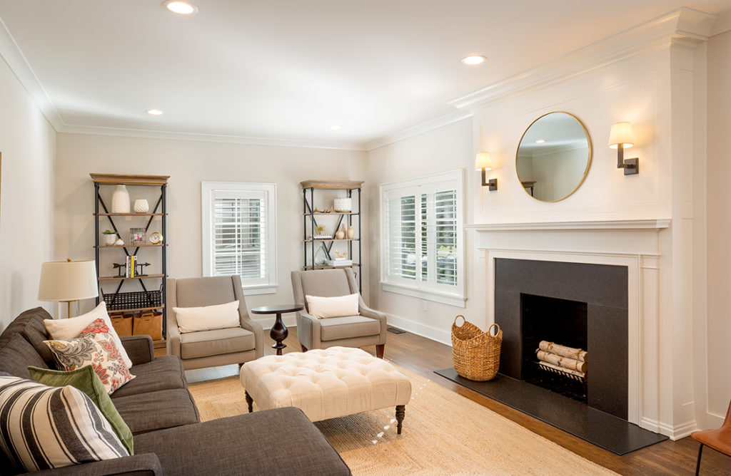 A renovated living room with a modern fireplace and new mantle by Epic Group Ohio.